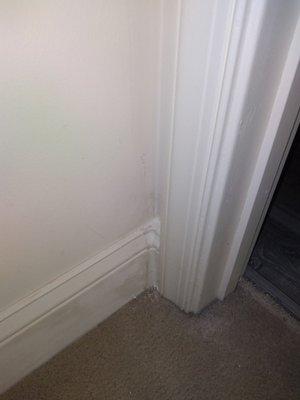 Caulking used to cover imperfections in the baseboard piece used in the corner.