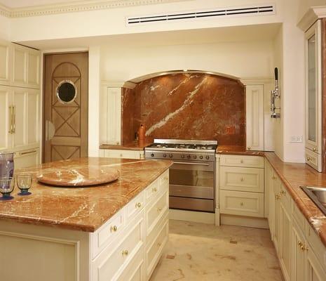 This kitchen has Red marble in both the countertops and backsplashes.