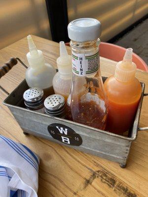 Sauces given to the table - honey, housemade Tabasco  sauce, habanero hot sauce