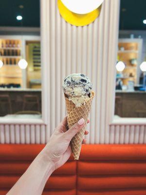 Scoop of cookies & cream and a scoop of coffee ice cream on a homemade waffle cone