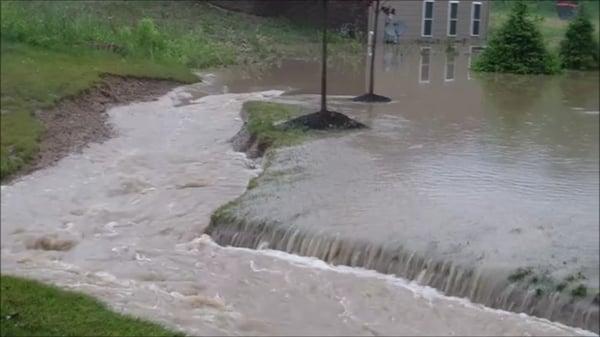 Trench with water flowing into street