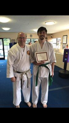 Sensei Kelly awarding a green brown belt after a test