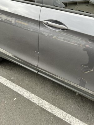 Parking lot hit and run, damaged passenger side front and rear door