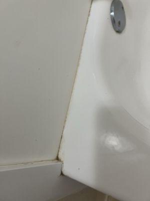 Dirt and grime on edge bathtub