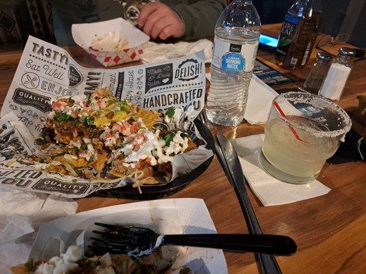 Food, margarita in rocks glass and store bought bottled drinks.