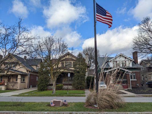 Flag and houses in view.