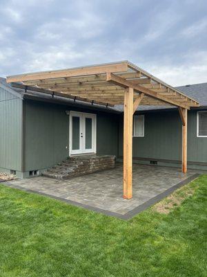 Paver patio with a paver landing and hand framed patio cover