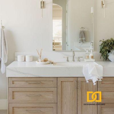 Spa like primary suite with Quartz counter and custom vanity in subtle colors with tall mirrors and sconces.