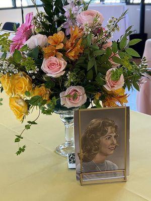 Each table included a floral centerpiece and a picture of mom - bonus, flip the picture over for another picture of her.