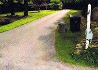 Residential service - containers emptied, area cleaned up, cans placed on side of drive