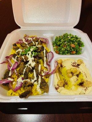 Beef Shawarma over rice, red onion and drizzled in tahini sauce. Served with tabouli salad and hummus