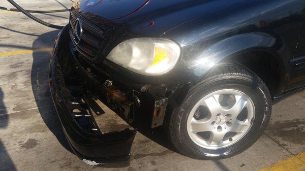 Car bumper torn half way off in car wash