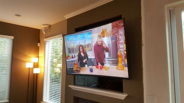 This curved 65" TV on a swivel mount required that we build a structure on which to mount it. The end result was very successful.