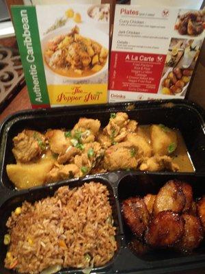 Curry chicken with sides of fried plantains and veggie fried rice.