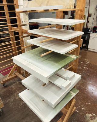 Using the drying rack to store cabinet parts.