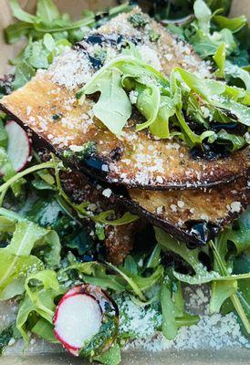 Delicious fried eggplant stack with tomato, mozzarella, arugula and basil pesto