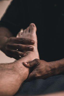 Clinton Muhammad massaging a foot