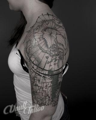 Best nautical design tattoo of geographical map on upper arm done in fusion style black and grey