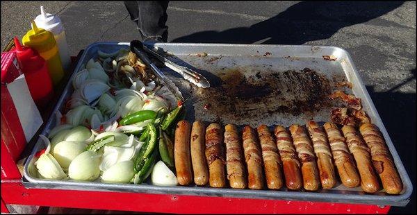 Delicious Dogs prepared amazing bacon wrapped hot dogs for today's event, from a propane-fired griddle on a push cart.