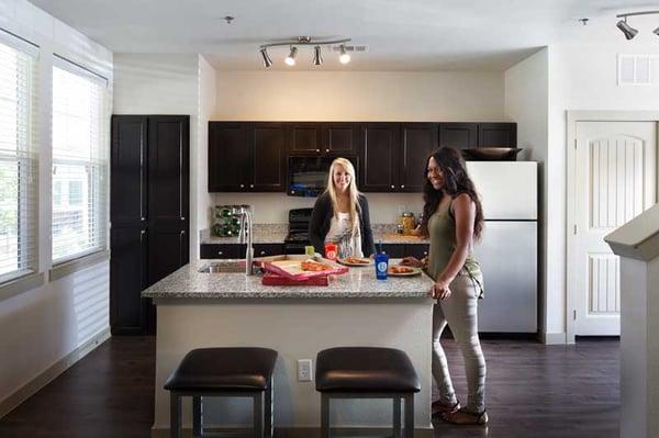 Modern kitchens boast private pantries and stainless steel refrigerators.