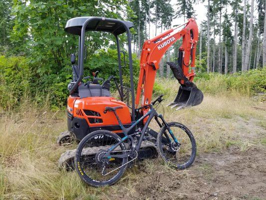 Two of our favorite things! Using the mini to build trails for our MTB resort.