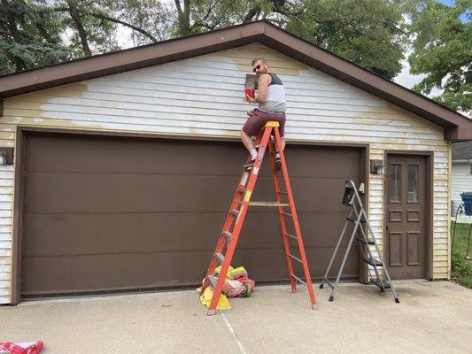 Repairing and painting siding on Garage.