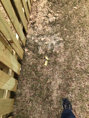 Dirt, rocks, and debris left in neighbors yard.