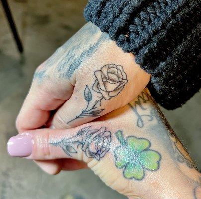 Matching rose tattoos by Anthony