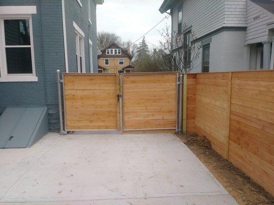 Cedar Horizontal privacy fence with with steel framed double gate.