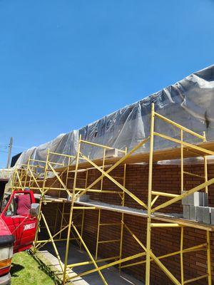 Built scaffolding to remove and rebuild part of a masonry wall.