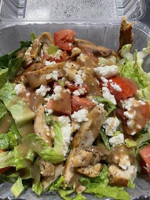 Salad with tomatoes, feta, grilled chicken and balsamic dressing.