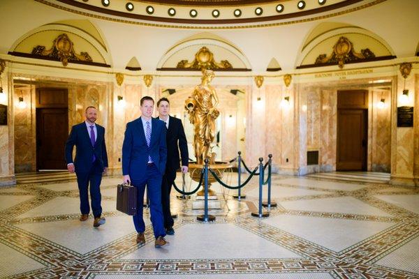 Attorneys Craig Meehan, Eric Eisinger and Brett Uhrich walking through courthouse.