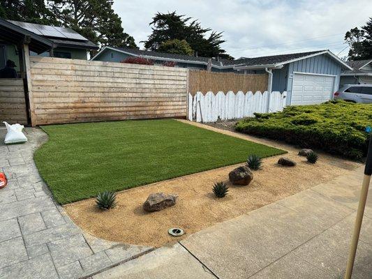 Complete Garden & Landscaping installed turf, agaves, boulders and decomposed granite.