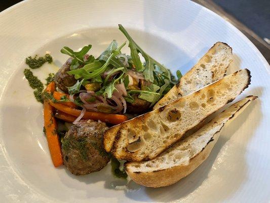 Lamb Meatballs $22 on a bed of ricotta, pesto, and arugula with grilled carrots, plus extra toasted bread.