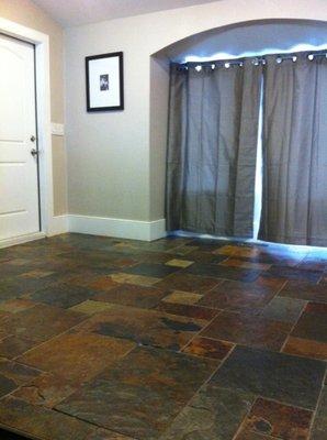 California Gold gauged slate flooring with a Versi pattern and enhancer/sealer finish.