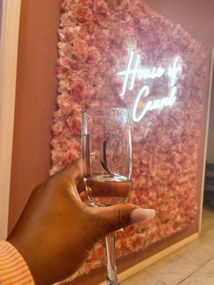 Enjoy a glass of champagne from your beauty professional