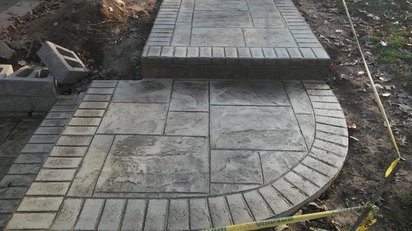 Stamped concrete sidewalk with brick border