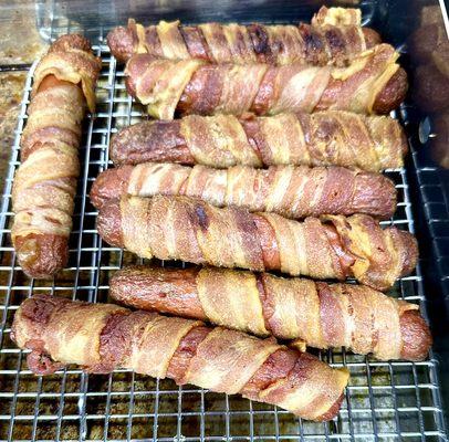 Bacon wrapped hot dogs waiting to be served. Either with chili cheese or fries or whatever you want to customize it with.