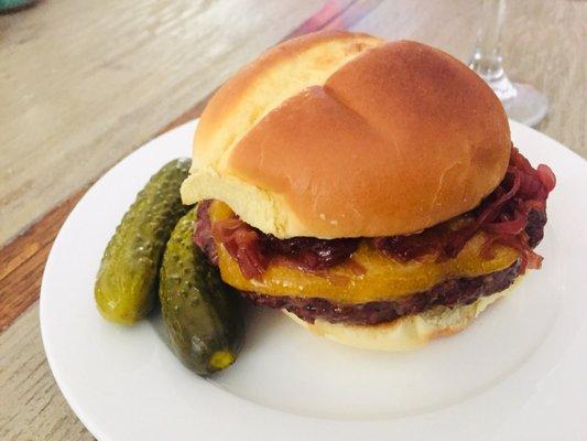 Smoked beef burger with cheddar and balsamic onions.