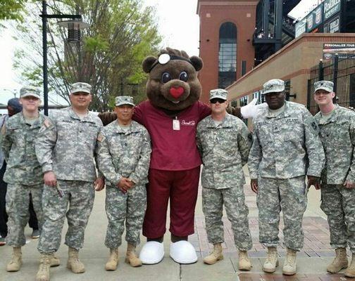 Percy our Care Bear Mascot with some of military  men