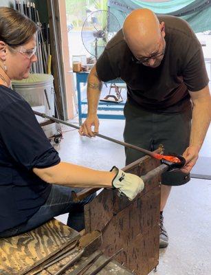 Rounding out the molten glass with a water-soaked wood ladle