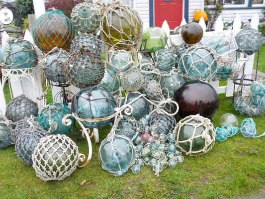 Fantastic collection of old nautical floats ranging in size from the rare under 2" to 14" diameter and unusual glass "rolling pin" floats.