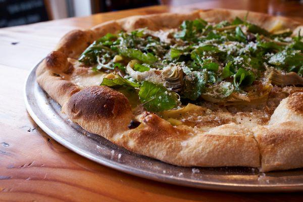 A special winter veggie pizza: artichoke and arugula.