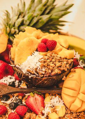 Tropical vibes. Organic acai, topped with fresh pineapple, mango coconut raspberries and granola.