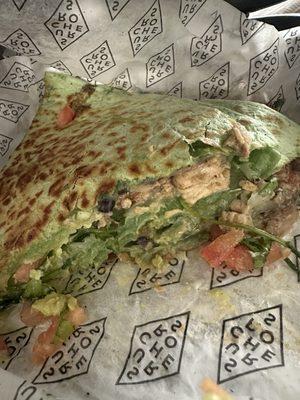 Chicken quesadilla with black beans pico and guacamole on spinach wrap