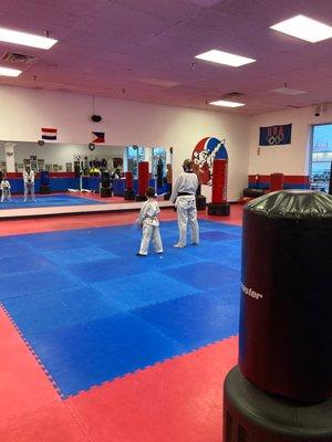 Master Morgan helping a student with his new green belt forms, while demonstrating patience and understanding!