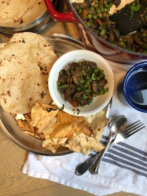 Plant-based mushroom curry served with roti and papad