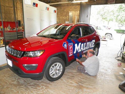 Wrapping of Malone's new Campus Safety vehicle