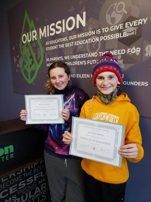 Addison and Jackson proudly display their Certificates of Achievement after completing their programs!!