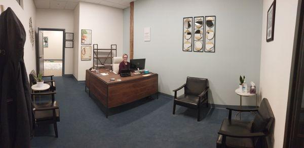 The front desk, friendly staff, and waiting room at Quality Care Chiropractic.